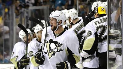 Brian Dumoulin, centre, of the Pittsburgh Penguins celebrates with his teammates after Patric Hornqvist scored an empty net goal during the third period against the San Jose Sharks after in Game 6 of the 2016 NHL Stanley Cup Final at SAP Center on June 12, 2016 in San Jose, California. Robert Reiners/Getty Images