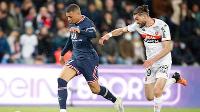 Kylian Mbappe takes the ball past Lorient's Leo Petrot during the Ligue 1 match at Parc des Princes. EPA