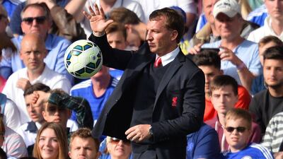 Liverpool manager Brendan Rodgers catches the ball on the touchline on Sunday during his side's Premier League draw with Chelsea. Glyn Kirk / AFP / May 10, 2015