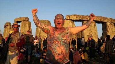 A reveller called Mad Alan (real name) celebrates the 2014 summer solstice at sunrise at the prehistoric monument Stonehenge. Geoff Caddick / AFP photo