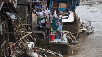 An Indonesian woman washes her clothes on a river bank in downtown Jakarta. Bay Ismoyo / AFP Photo