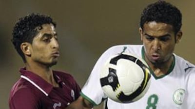 Qatar's Mesaad Alhamad, left, battles with Saudi Arabia's Abdo Ateef during the goalless draw.