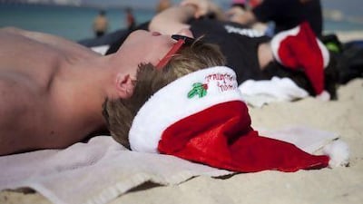 Nick Cifranic, 19, a student at the Rochester Institute of Technology, enjoys the sunshine at the JBR beach on Christmas day. Nick is in Dubai for a study abroad programme from New York. Razan Alzayani / The National