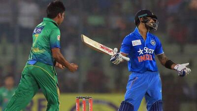 Pakistan's Mohammad Samir, left, reacts after the dismissal of India's Virat Kohli during the Asia Cup T20 cricket tournament match between India and Pakistan at the Sher-e-Bangla National Cricket Stadium in Dhaka on February 27, 2016. India trounced bitter rivals Pakistan by five wickets in a one-sided affair at the Asia Cup Twenty20 tournament. AFP