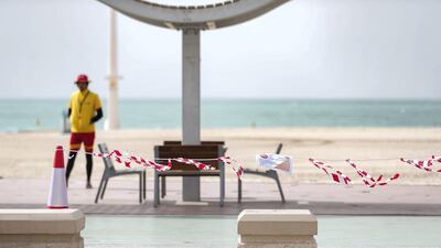 Lifeguards patrol an empty Jumeirah Beach in Dubai. Chris Whiteoak / The National