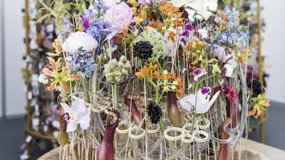 Tamas Mezoffy of Hungary was the first runner-up. The round shape of his environmentally responsible arrangement symbolised an eternal circle, which was merged with modern floristry. His use of transparent plastic and rubber tubes evoked clean reservoirs of water, colourless and pale. Meanwhile, colourful flowers imbued with gold foliage presented “a celebration of the renewal of life”. Reem Mohammed / The National