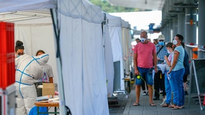Travellers arriving from abroad wait to be tested at a Covid-19 testing station set up at Cologne-Bonn Airport on August 8, 2020 near Cologne, Germany Getty
