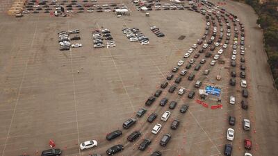 This aerial view shows people waiting in line in their cars at a Covid-19 testing site at Dodger Stadium in Los Angeles. AFP
