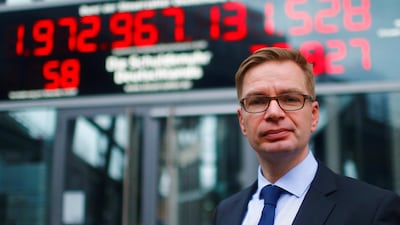 President of the Federation of German Taxpayers, Reiner Holznagel, stands in front of the so-called debt clock (Schuldenuhr), which is running backwards for the first time in its 22-year existence, in Berlin, Germany December 22, 2017. REUTERS/Hannibal Hanschke