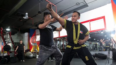 Guro deflects a mock knife attack. Ruel Pableo for The National