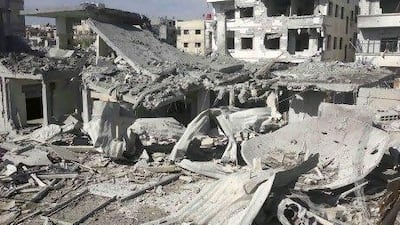 Buildings are damaged after a Syrian Air Force fighter jet fired missiles at Erbeen, near Damascus. Government jets carried out five strikes in the eastern Ghouta district, a rebel stronghold close to the capital, human rights activists say.