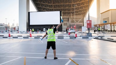 The drive-in cinema is making a comeback at Mall Of The Emirates, and a large screen has been assembled in the shopping centre's upper parking lot, on level 3, right underneath Ski Dubai's slope. Patrons take position, switch off their engines and settle in for the film. Reem Mohammed / The National