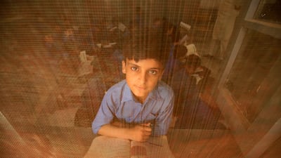 A Pakistani boy attends a class on International Literacy Day in Peshawar on Friday. EPA