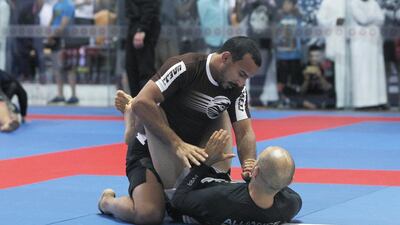 Emirati jiu-jitsu black belt holder Mohammed Al Qubaisi, top, and Faisal Al Ketbi lead a 13-strong team to the Grand Slam Rio de Janeiro, the penultimate leg of the Abu Dhabi World Tour. Jeffrey E Biteng / The National