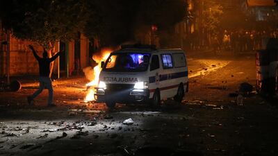 An ambulance arrives on the scene of a protest against the newly appointed Lebanese prime Minister Hassan Diab, at Corniche Al-Mazraa neighborhood in Beirut, Lebanon. EPA