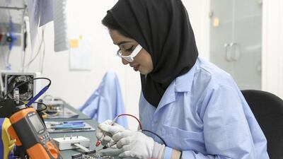 Teams from Mohammed bin Rashid Space Centre and American University of Sharjah work on preparing the ground station at AUS which will operate the satellite after it launches from India. Courtesy Mohammed bin Rashid Space Centre