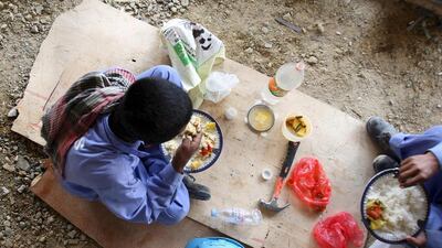 Construction workers enjoy a long midday break in the summer months to minimise the effect of the severe temperatures. Ali Haider / EPA