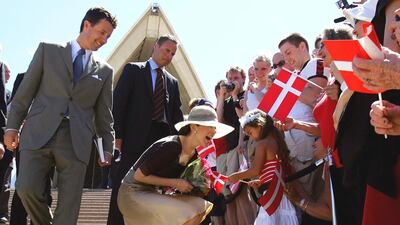 The royal couple greet people on the steps of the Sydney Opera House in Australia in 2005. AP