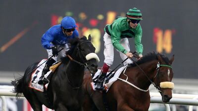 Irish jockey Jamie Spenser, right, on Certerach competes near Brazilian Silverstre De Sousa on Cavalryman before winning the Dubai Gold Cup race at Meydan Racecourse. Marwan Naamani / AFP