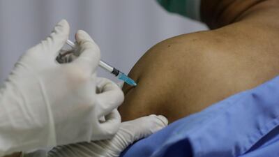 A healthcare worker injects a dose of the Sinopharm vaccine during the first day of a private vaccination drive for workers at Indah Kiat Pulp and Paper Company, on the outskirts of Jakarta, Indonesia. EPA