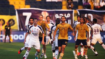 Al Ain and Dubai players look for the ball to come down out of the sun during a corner. Lee Hoagland/The National