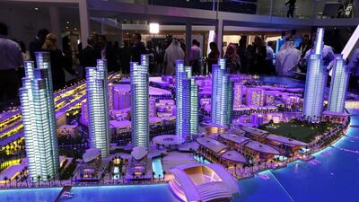 Dubai Properties' Culture Village project, sized down to scale, is bathed in light at the Cityscape Global. Pawan Singh / The National