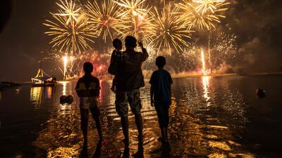Local residents look at fireworks as they celebrate the New Year at Ancol Beach in Jakarta. AFP