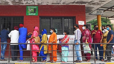 People queue to collect their Covid-19 test results at a hospital in Amritsar on July 17, 2020 as India's confirmed coronavirus cases passed one million. AFP