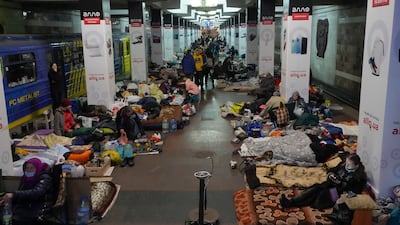 People rest with their belongings in a city subway being used as a bomb shelter in Kharkiv, Ukraine. AP