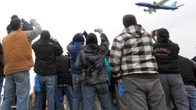 Plane spottters take pictures of the first production Boeing 787 Dreamliner take off at Paine Field in Everett, Washington in 2009. Etihad's first Dreamliner is due to arrive in the capital next month with its new 'Facets of Abu Dhabi' livery. John Froschauer / AP Photo