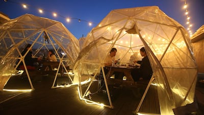 People enjoy outdoor dining at plastic bubbles, observing social distancing against the spread of the coronavirus at a restaurant near the Han River in Seoul, South Korea. AP Photo