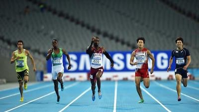Nigerian-born Femi Ogunode, centre, represented Qatar at the Asian Games in Incheon, South Korea. He won the 100-metre race in an Asian record time of 9.93 seconds. Manan Vatsyayana / AFP