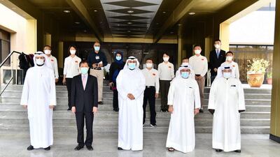 Hand out photo released by KUNA on April 28, 2020, shows Kuwait's Health Minister Sheikh Basil al-Sabah (C), as he receives members of a Chinese health delegation visiting Kuwait to exchange experiences on strategies, plans, and procedures to contain COVID-19 coronavirus disease. AFP