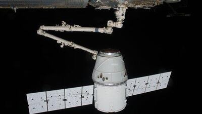 the SpaceX Dragon commercial cargo craft is grappled by the Canadarm2 robotic arm at the International Space Station.