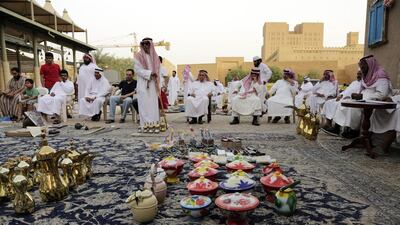 A group of elderly Saudi women have their own corner in the market where they sell cotton dresses worn by women around the house. Dusty metal jewellery sits in piles inside woven baskets for buyers to rummage through, most of it made in Pakistan.