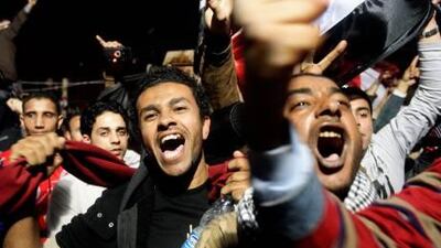 Egyptian anti-government protesters in Tahrir Sqare, Cairo react minutes after the anouncement of the resignation of President Hosni Mubarak from his post.