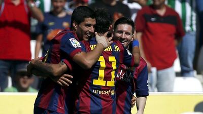Luis Suarez celebrates a goal with fellow forwards Neymar, centre, and Lionel Messi, right, during Barcelona's victory over Cordoba. Javier Barbancho / Reuters