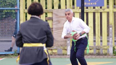 Mr Khan plays flag football on a visit to the BIGKID Foundation in Lambeth. Reuters