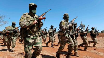 Members of Hayat Tahrir Al Sham train at a camp in Syria's north-western Idlib province. AFP