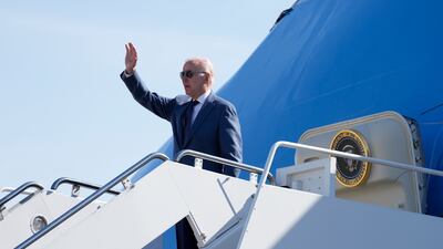 Joe Biden waves from the steps of Air Force One as he sets off for Northern Ireland on Tuesday. AP