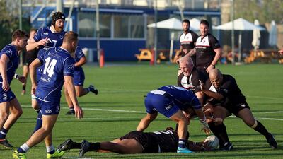 Jebel Ali Dragons, in blue, and Dubai Exiles were involved in a bad-tempered match at the weekend. Satish Kumar for the National