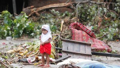 A girl stands among debris in Tanjung Lesung. EPA
