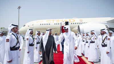 President Sheikh Mohamed is received by Sheikh Tamim, Emir of Qatar, on his arrival at Doha International Airport on September 10. Abdulla Al Neyadi / UAE Presidential Court