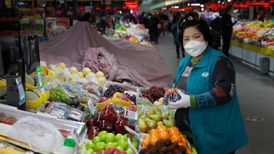 epa08208368 A Chinese vendor sorts vegetables at a market in Beijing, China. EPA