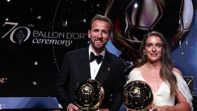 Spain and Barcelona midfielder Alexia Putellas and England and Bayern Munich forward Harry Kane pose with their trophies. AFP