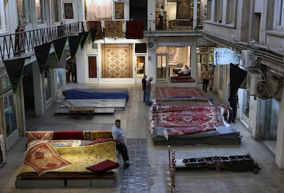 An Iranian carpet seller waits for customers at the Tehran Grand Bazaar. EPA