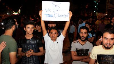 Iraqis carry banners and chant slogans during a demonstration in Karbala city, southern Iraq, last week. Furqan Al Aaraji / EPA