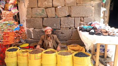 A Yemeni market trader sells dried fruit in Sanaa before Eid. AFP