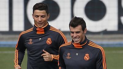 Real Madrid players Cristiano Ronaldo, left, and Gareth Bale run during a training session at Real Madrid’s Valdebebas training grounds outside Madrid April 22, 2014. the day before Real Madrid play Bayern Munich in a Uefa Champions League semi-final, first leg match in Madrid on Wednesday. REUTERS/Andrea Comas