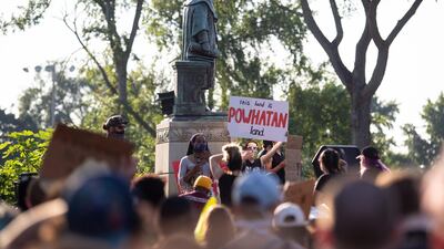 Protesters surround a statue of Christopher Columbus before marching, eventually returning and pulling it down in Richmond, Virginia. Another statue of Christopher Columbus was beheaded in Boston. AFP